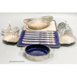 A George V silver two handled butter dish, with blue glass liner, a white metal basket, a pair of