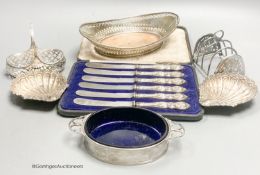 A George V silver two handled butter dish, with blue glass liner, a white metal basket, a pair of