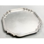 A square silver waiter with piecrust border, inscribed, Birmingham 1956, 25.9cm, with engraved