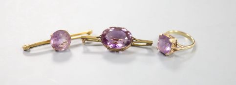 A modern 9ct gold and amethyst set dress ring and two yellow metal and amethyst set bar brooches,