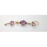 A modern 9ct gold and amethyst set dress ring and two yellow metal and amethyst set bar brooches,