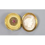 An early 20th century 9ct mounted oval cameo shell brooch, 36mm and an earlier yellow metal and gem