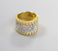 A modern pierced 750 yellow metal and diamond chip set dress ring, size M/N,gross weight 11.4