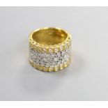 A modern pierced 750 yellow metal and diamond chip set dress ring, size M/N,gross weight 11.4