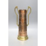 A Secessionist style copper and brass two handled cup, 40cm