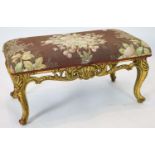 A Louis XV style carved giltwood dressing stool, with a pierced apron, on short cabriole legs,