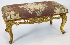 A Louis XV style carved giltwood dressing stool, with a pierced apron, on short cabriole legs,