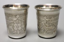 A pair of 19th century Russian engraved 84 zolotnik tots, dated 1879, 48mm, 52 grams.