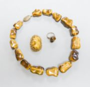 A Middle Eastern gilt white metal and tiger's eye pebble necklace, 48cm and a similar brooch and
