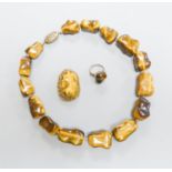 A Middle Eastern gilt white metal and tiger's eye pebble necklace, 48cm and a similar brooch and