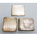 Three assorted George V silver cigarette cases, largest 9.8cm, gross weight 11.5oz.