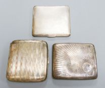 Three assorted George V silver cigarette cases, largest 9.8cm, gross weight 11.5oz.