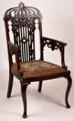 A late Victorian carved mahogany elbow chair