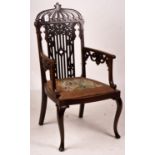 A late Victorian carved mahogany elbow chair