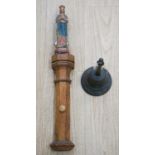 An early hand bell and a religious figure on an oak pilaster65cm