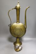 A Persian engraved brass ewer and Middle-eastern horn and white metal priming shot flask57cm