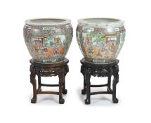 A pair of Chinese famille rose fish bowls on ebonised marble inset stands, diameter 56cm, total