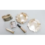 A pair of modern silver ashtrays, two metal lighters, a silver mounted cigar piercer and a white