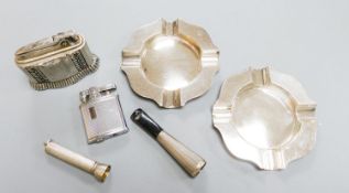 A pair of modern silver ashtrays, two metal lighters, a silver mounted cigar piercer and a white