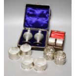 Four pairs of silver napkin rings including cased Victorian and a cased pair of silver pepperettes.