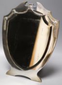 An Edwardian silver mounted shield shaped easel mirror, Henry Matthews, Birmingham, 1909, 32.5cm.