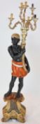An 18th century style Venetian design polychrome painted carved wood blackamoor figure, poised as