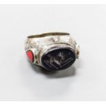 A continental engraved white metal and oval intaglio black onyx ring, with two colour enamel set