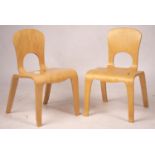 A pair of ‘Comunity’ ergonomic design children’s chairs, 55cm high max.