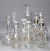 A pair of Regency small cut glass decanters, a pair of silver-mounted 'dimple' decanters, another