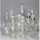 A pair of Regency small cut glass decanters, a pair of silver-mounted 'dimple' decanters, another