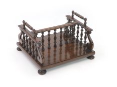 A William IV rosewood bookcarrier / rack,with ring turned handles, baluster turned frame and pad
