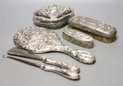 A late Victorian repousse silver mounted hand mirror, London, 1899, two silver mounted glass