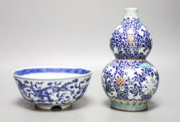 A 19th-century Chinese blue and white dragon bowl and a Chinese enamelled porcelain double gourd