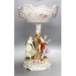 A German porcelain fruit stand, the stem decorated with four dancing figures51cm