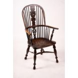 A mid 19th century yew and elm Yorkshire area Windsor armchair with saddle-seat and crinoline
