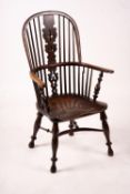 A mid 19th century yew and elm Yorkshire area Windsor armchair with saddle-seat and crinoline