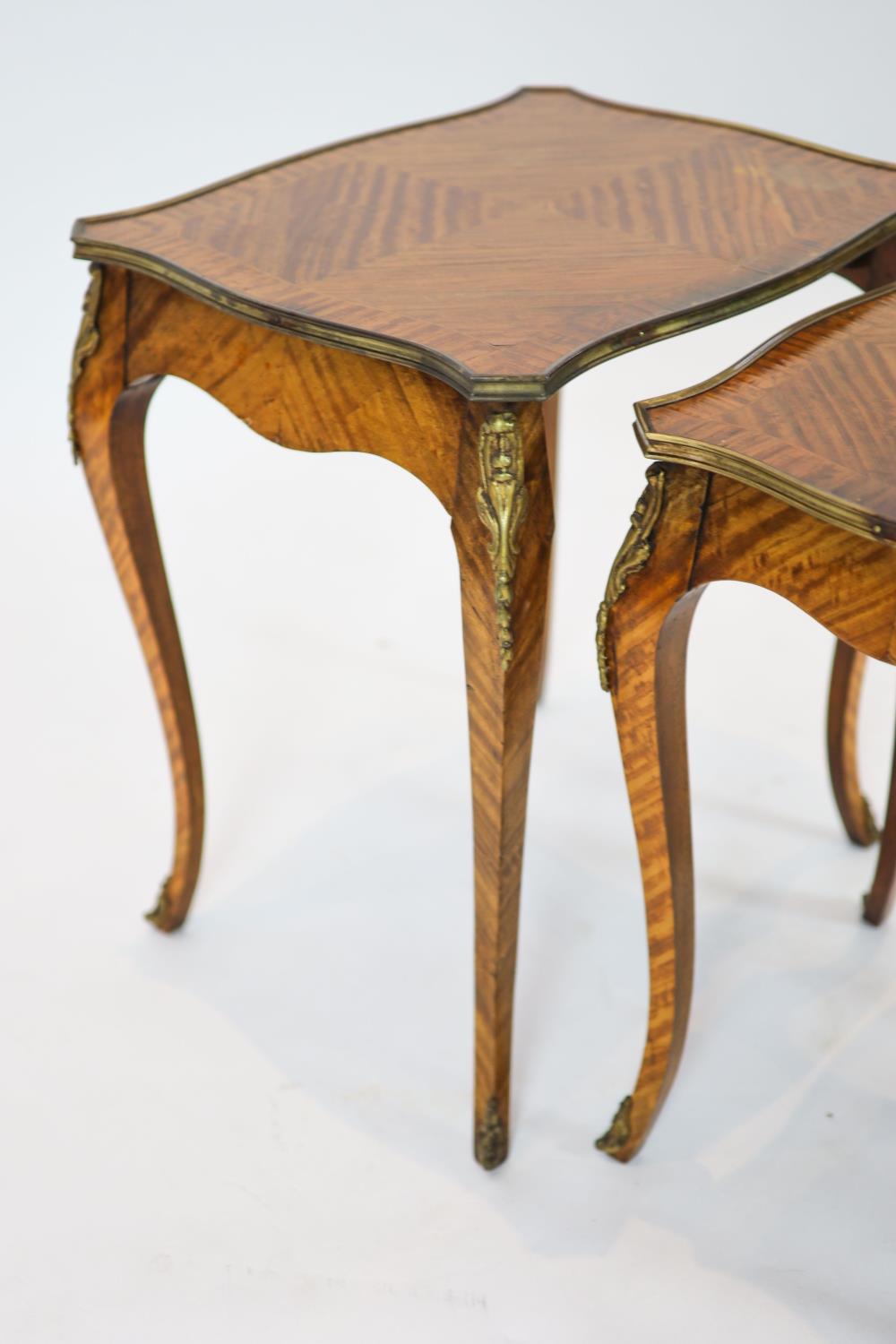 A nest of three Louis XV style ormolu mounted banded kingwood tables, with serpentine sides, on - Image 3 of 4