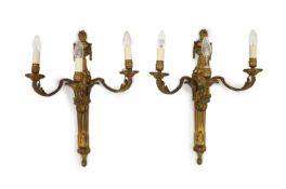 A pair of Louis XVI style ormolu three branch wall lightswith urn crested lion’s mask stems and