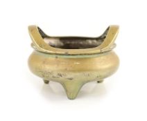 A large Chinese bronze tripod censer, ding, Xuande mark, Qing dynasty,the rim with a pair of high