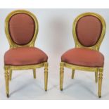 A pair of 19th century Louis XV style giltwood framed side chairs, with oval carved backs, on turned