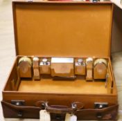A 1930's Harrods pigskin travelling toilet case with seven engine turned silver fittings,