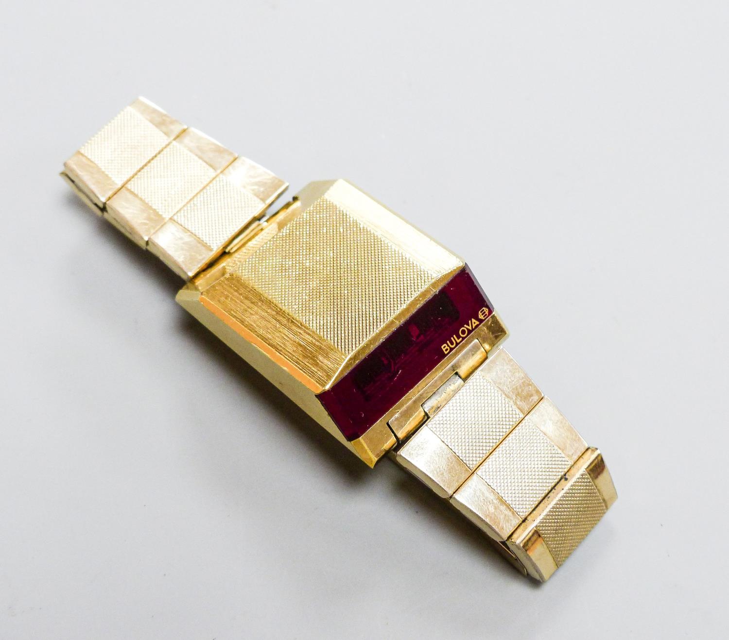 A gentleman's steel and gilt base metal Bulova digital wrist watch, on Bulova bracelet, case