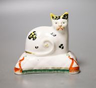 A Staffordshire porcelain model of a cat seated on a cushion, c.1835–50,Provenance - Dennis G.