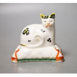 A Staffordshire porcelain model of a cat seated on a cushion, c.1835–50,Provenance - Dennis G.