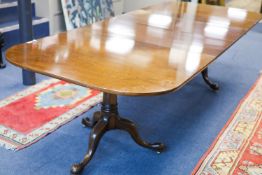 A George III style mahogany two pillar extending dining table, length 276cm extended, two spare