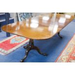 A George III style mahogany two pillar extending dining table, length 276cm extended, two spare