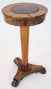 A Regency banded rosewood circular topped work table, raised on tapered, turned pillar, on a triform