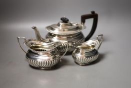 A late Victorian demi-fluted three piece tea set, Nathan & Hayes, Chester, 1896,gross weight 22.