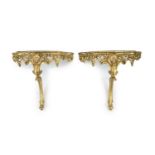 A pair of Louis XV style carved giltwood console tablesWith serpentine white marble tops, scroll and