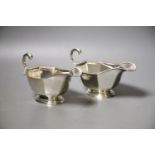 A pair of 1930's silver sauceboats, with flying scroll handles, 16.2cm, 8oz.